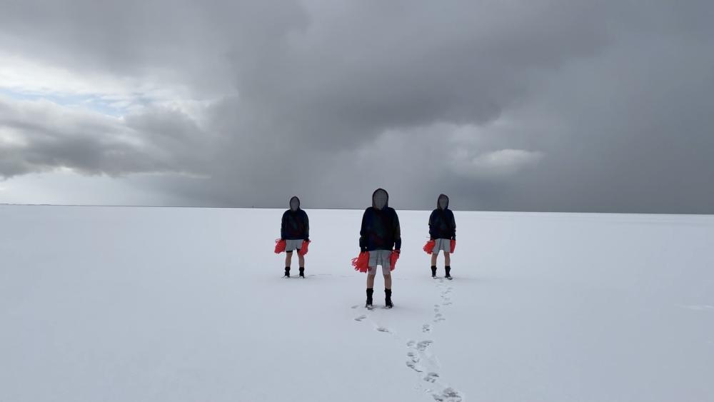 Three people standing in snow