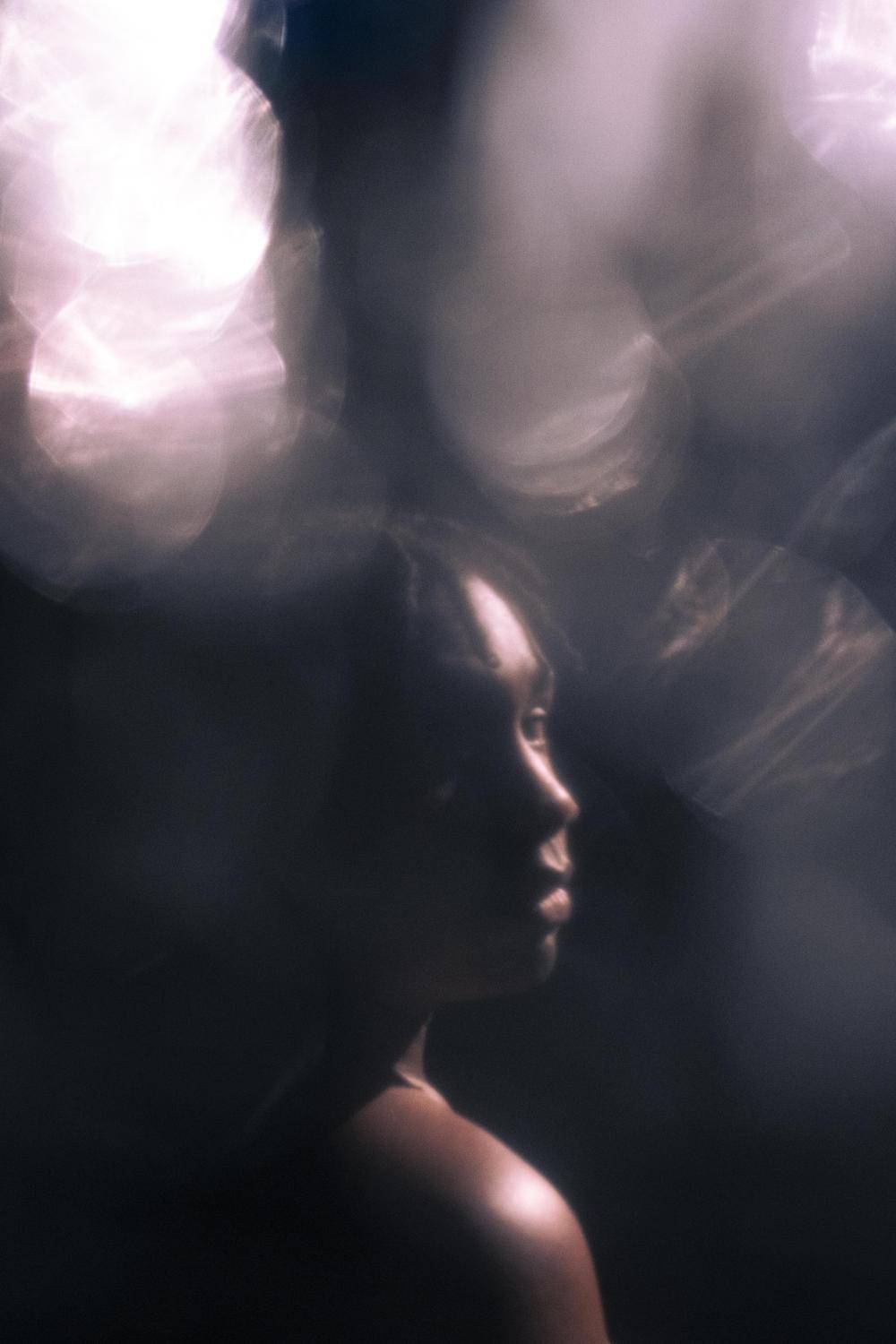 Black person in spotlight on stage 